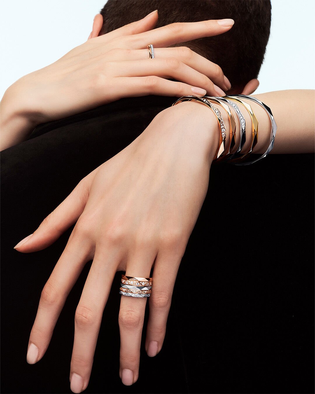 Image shows model hands wearing Laurence Graff Signature collection rings and bangles