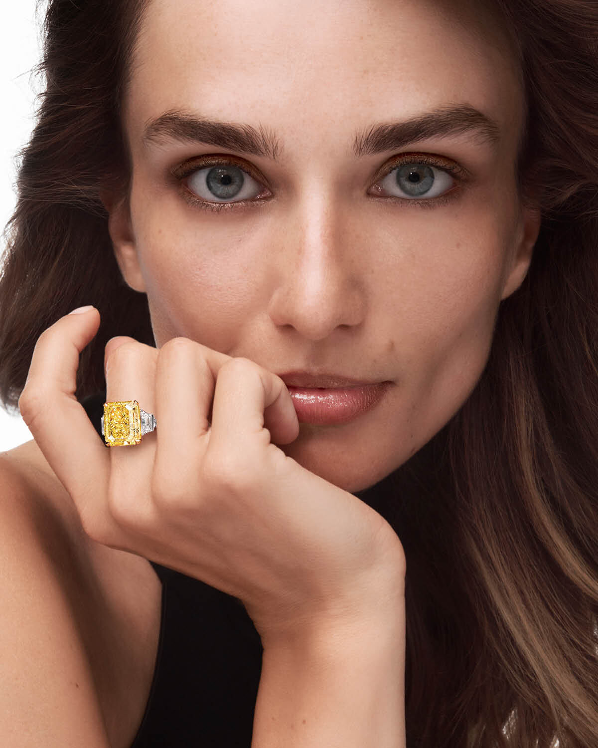 Unique Solitaires - model wears Graff yellow and white diamond solitaire ring