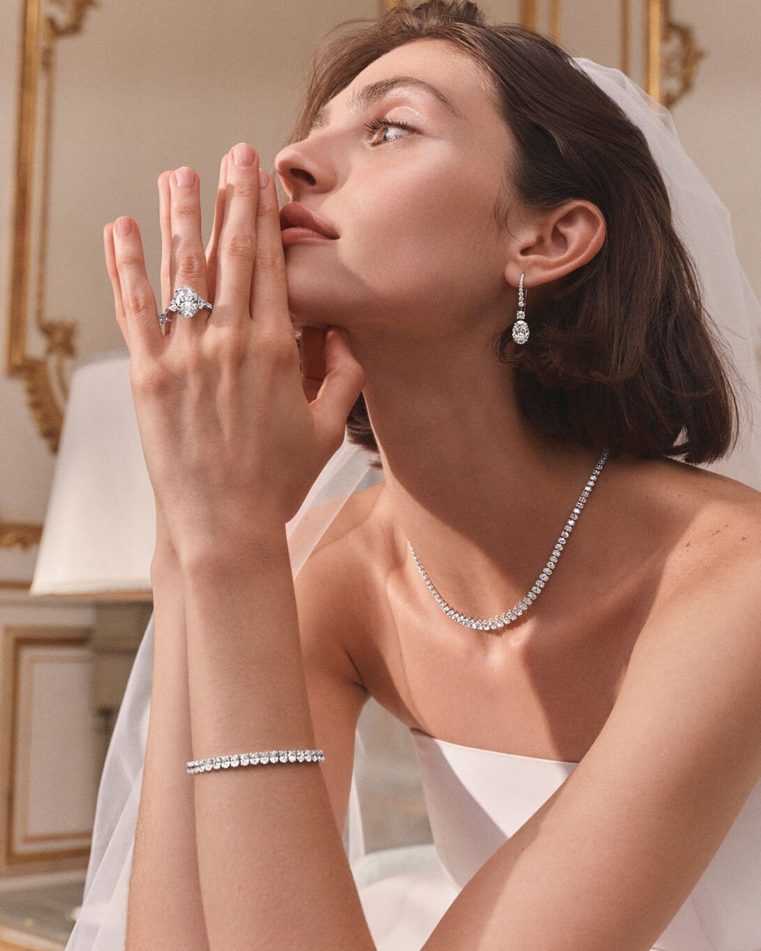 Female model wears Graff Oval Cut white diamond Classic Graff Bridal Jewellery