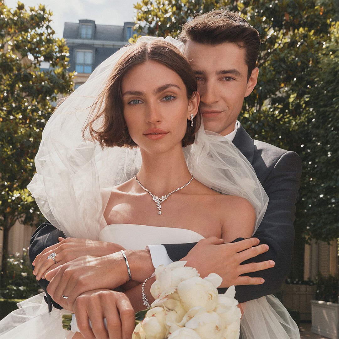 Image of female and male model wearing Graff Butterfly bridal jewellery and Laurence Graff Signature Collection jewellery