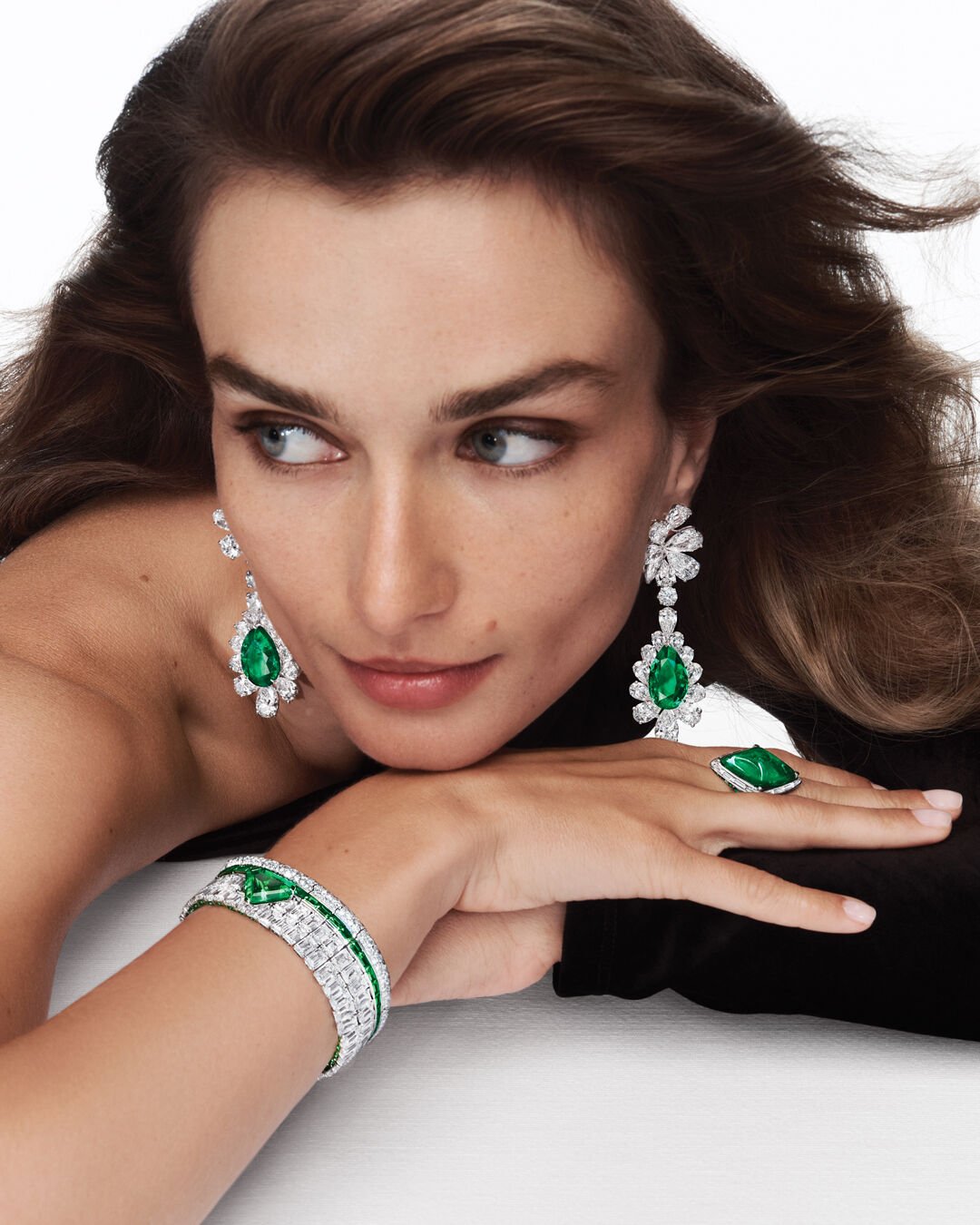 Unique Solitaires - model wears Graff Emerald High Jewellery suite