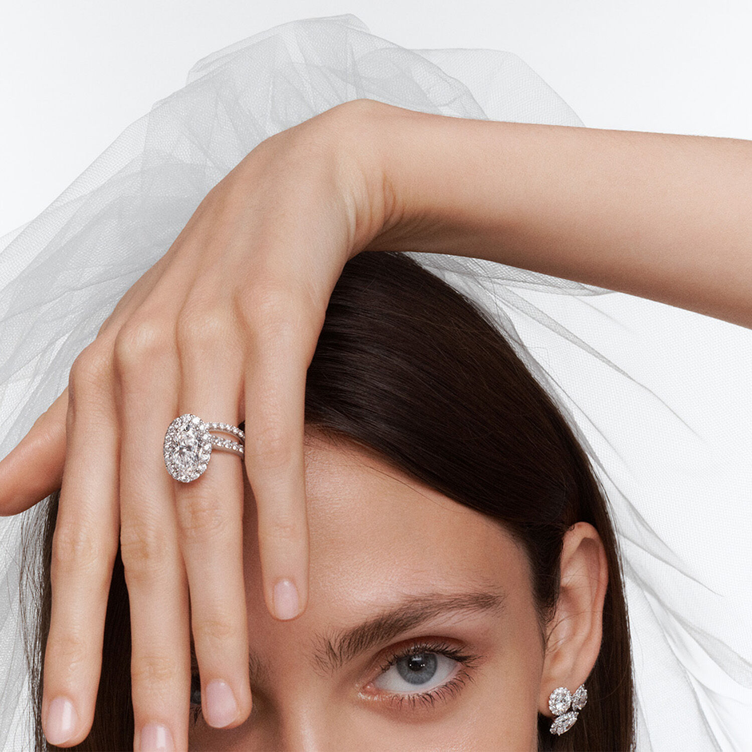 Female model wearing Graff Icon Engagement ring, diamond wedding band and Graff Icon earrings